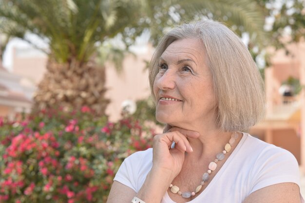 Portrait of a senior woman on a walk in tropic resort