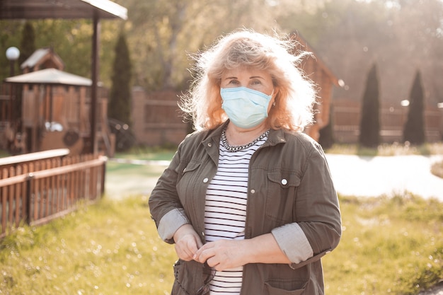 Foto ritratto della donna senior che indossa maschera medica. concetto di coronavirus. protezione respiratoria