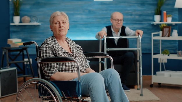 Portrait of senior woman with disability in nursing home. Retired person sitting in wheelchair and looking at camera in space for recovery and rehabilitation. Adult with physical disability