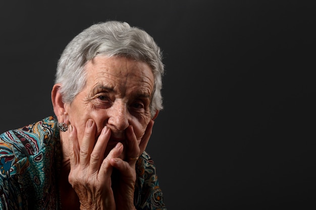 Portrait of a senior woman with gray background