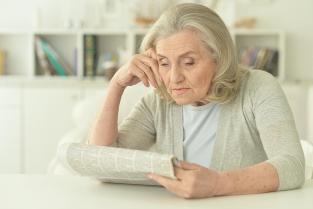 Portrait of a senior woman with newspaper