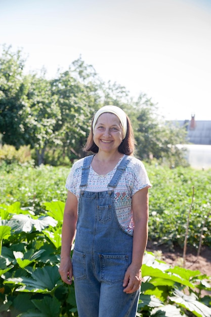 Portrait of senior woman working in garden in summer Hobbies for elderly concept