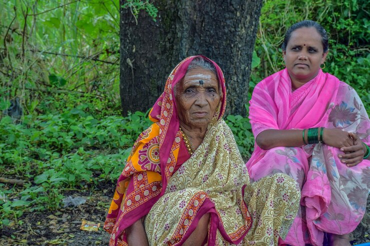 फोटो portrait of senior women sitting against trees outdoors