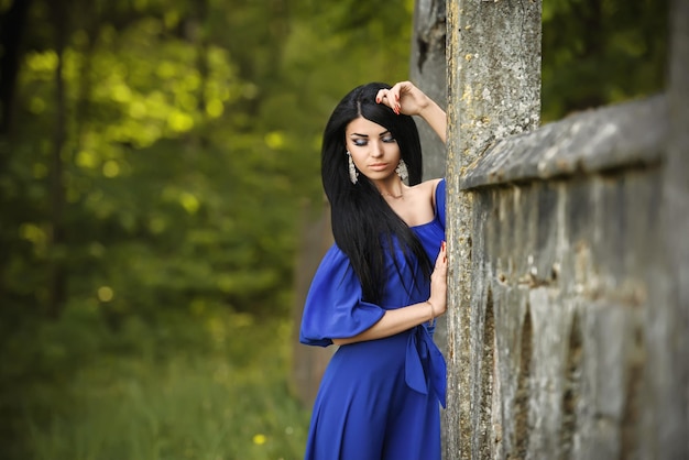 Portrait of sensual fashion young woman in blue dress outdoor