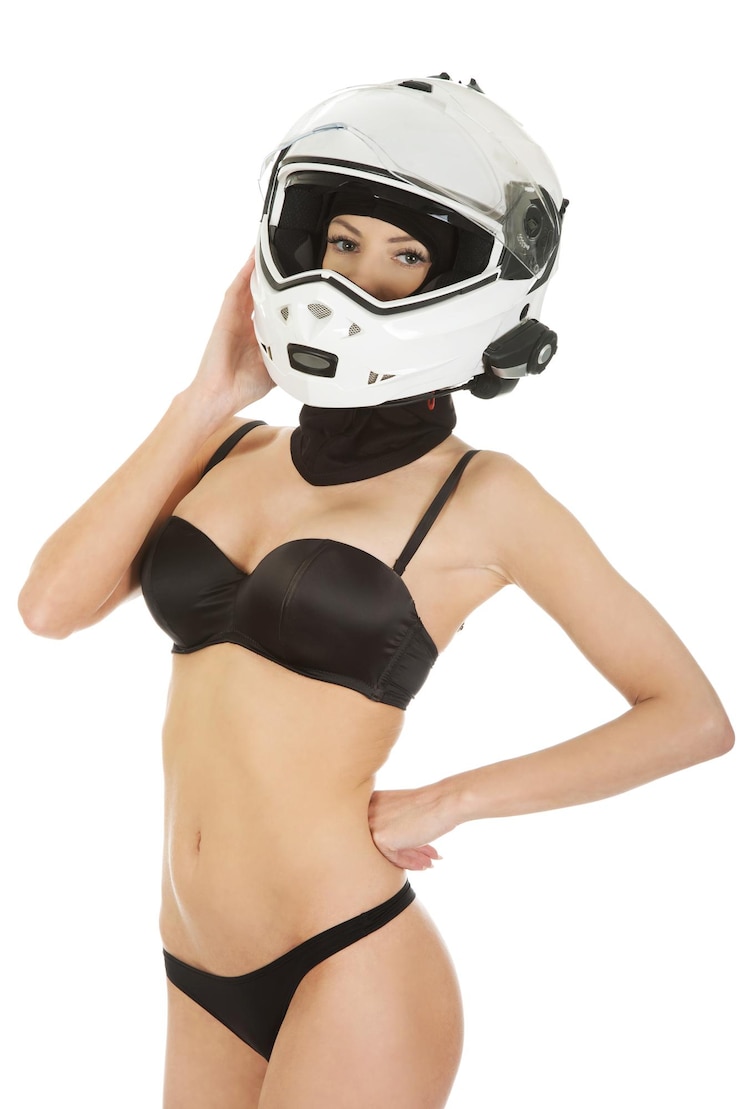 Photo portrait of sensuous woman wearing helmet and bikini while standing against white background
