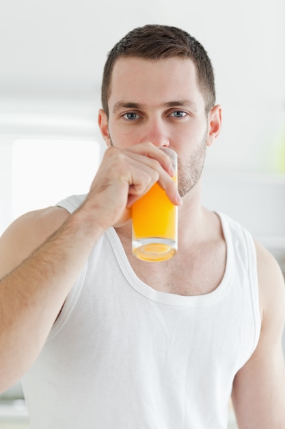 portrait of a serene man drinking orange juice