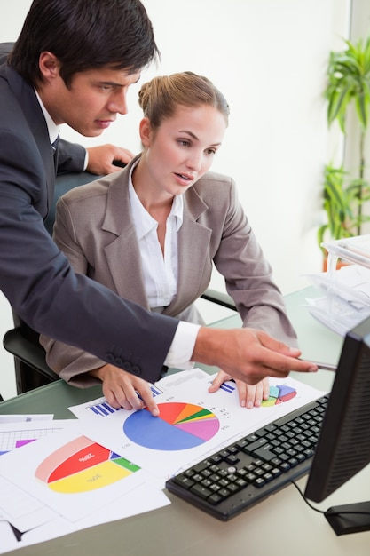 Portrait of a serious business team studying statistics