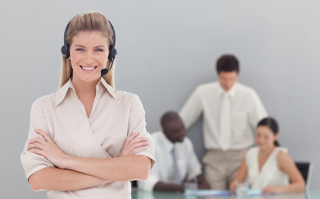 Portrait of a serious businesswoman standing with her collegues