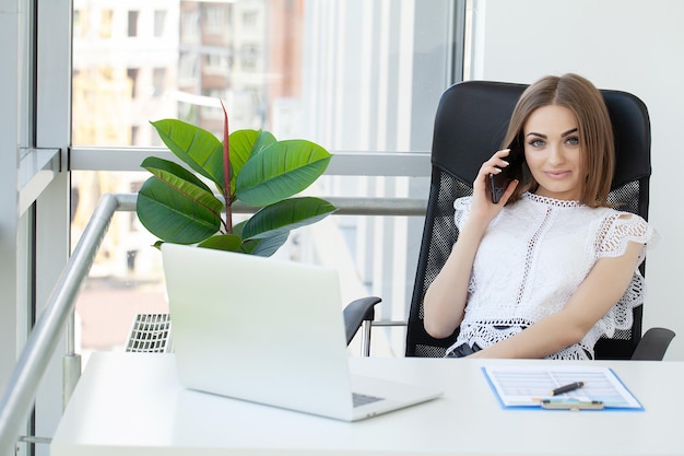 Portrait of a serious businesswoman using laptop in office