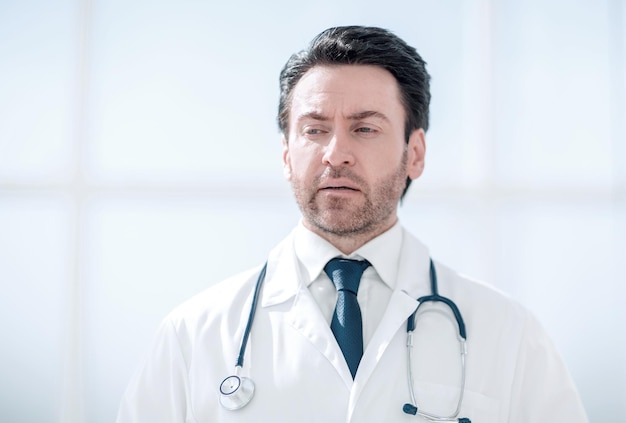 Portrait of serious doctor on blurred background the concept of health