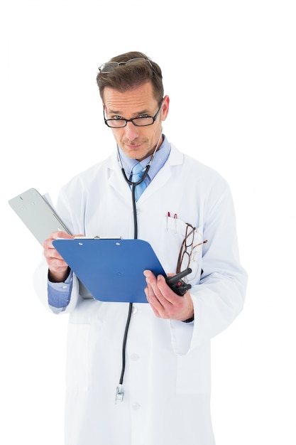 Portrait of a serious doctor with clipboard