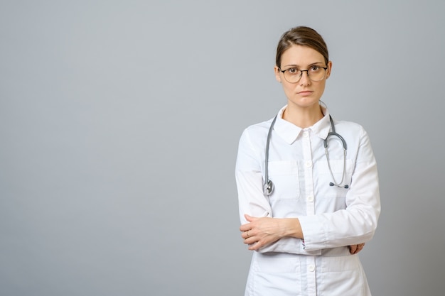 Portrait of serious doctor with stethoscope posing. Medical physician doctor woman