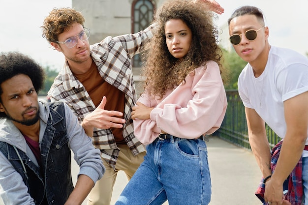 portrait of serious group of four friends outdoors