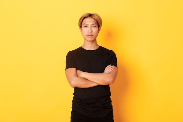 Portrait of serious-looking confident asian guy in black t-shirt