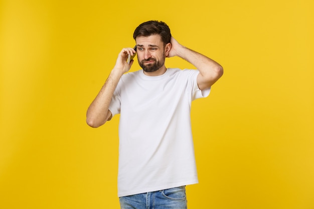 Portrait of a serious man talking on the phone isolated