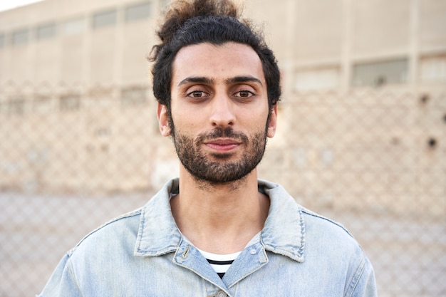 Portrait of a serious muslim young man looking at camera