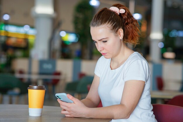 Portrait of serious sad frustrated upset girl, young upset disappointed woman looking at her cell