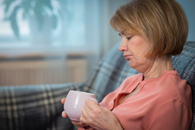 Portrait of serious sad upset depressed pensive thoughtful woman, elderly senior frustrated unhappy