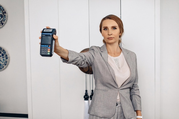 Portrait of a serious working woman holding the terms on her outstretched hand. Concept of concentration.