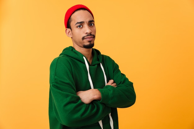 Portrait of a serious young afro american man in hat