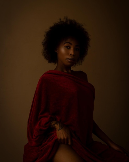 portrait of serious young woman over black background
