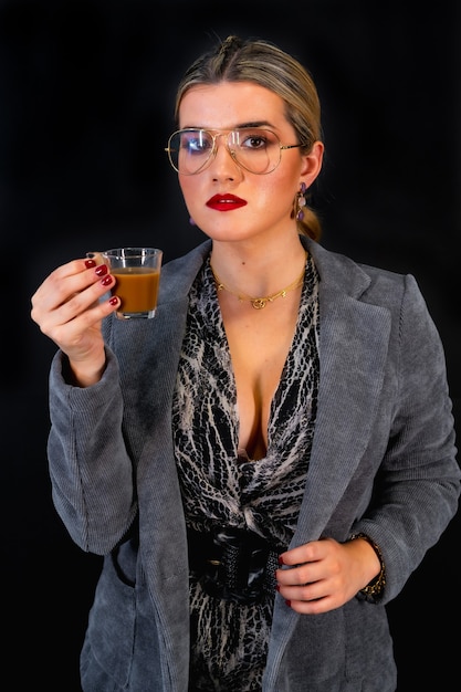 Portrait of a sexy caucasian businesswoman, drinking coffee