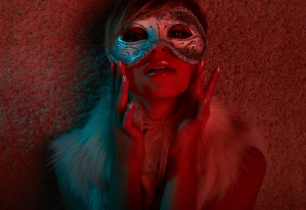 Portrait of Sexy girl in fur jacket wearing mask