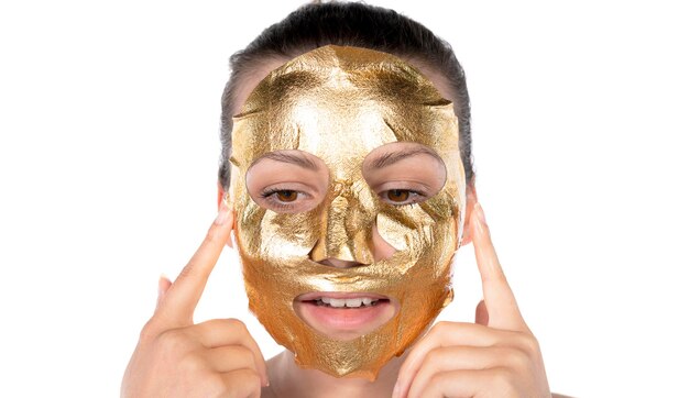 Portrait Of Sexy Healthy Girl Removing, Peeling Cosmetic Gold Mask From Beautiful Face Skin