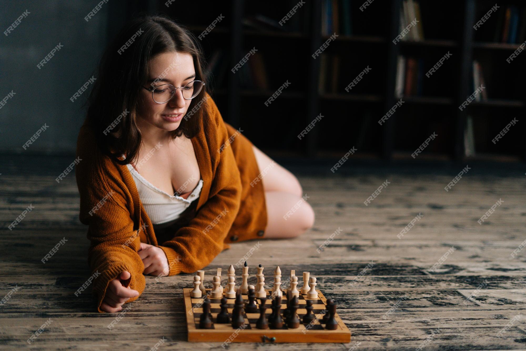 Woman playing chess thinking of next move Stock Photo - Alamy