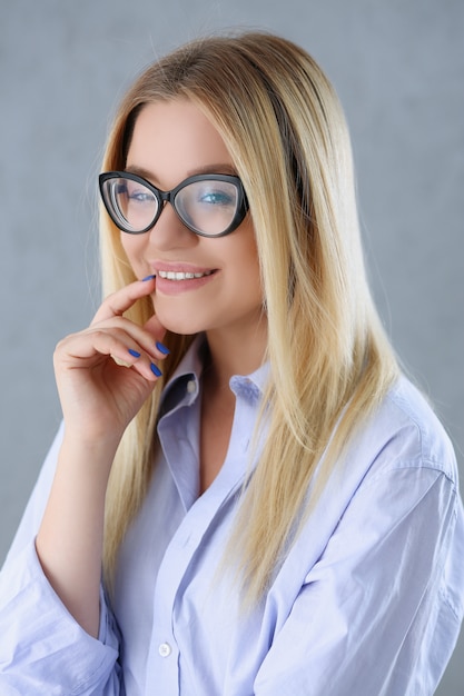 Photo portrait of a sexy woman in a man's shirt wearing glasses
