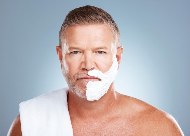 Portrait shaving cream and old man in studio for skincare grooming and beauty on grey background Face product and hair removal for mature model relax with luxury skin and beard foam isolated