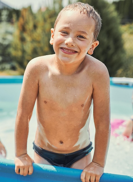 Portrait of shirtless boy in wading pool