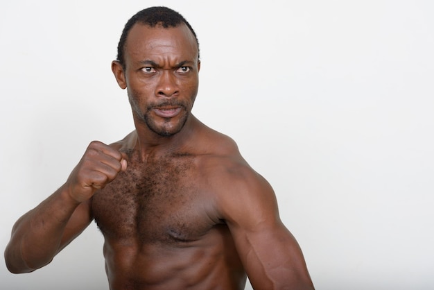 Portrait of shirtless man against white background