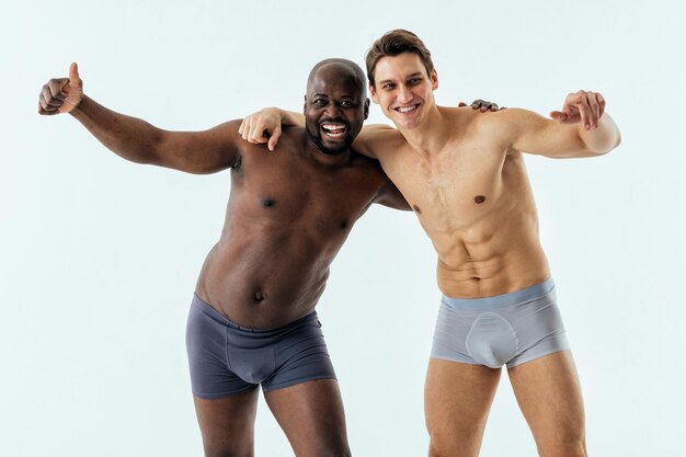 Portrait of shirtless man standing against white background