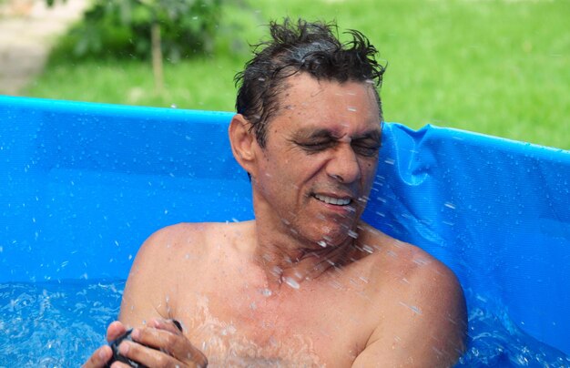 Portrait of shirtless man in swimming pool