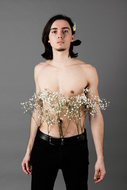 Portrait of shirtless man wearing flowers in his hair