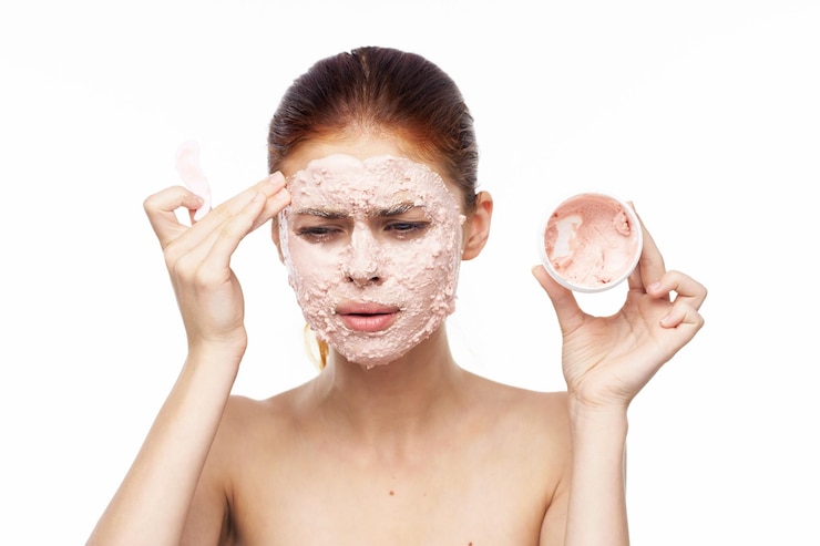फोटो portrait of shirtless senior woman holding dentures against white background