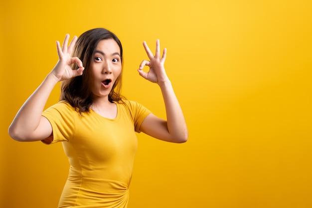 Portrait of shock woman against yellow background