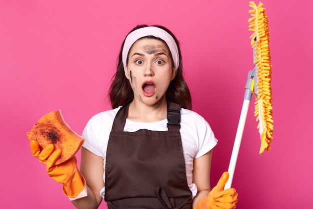 Portrait of shocked exhausted cute woman with wide opened mouth and eyes