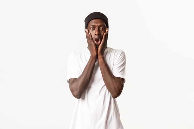 Portrait of shocked and impressed african-american cool guy in beanie