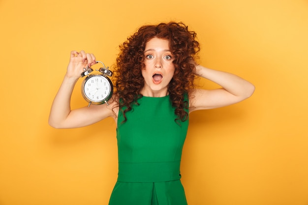 Portrait of a shocked redhead woman in dress