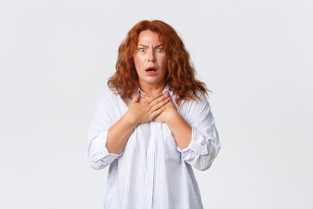 Portrait of shocked and worried, startled middle-aged woman being ambushed