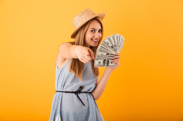 Portrait of a shocked young blonde woman in summer hat