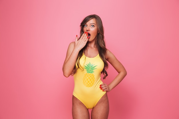 Portrait of a shocked young woman dressed in swimsuit