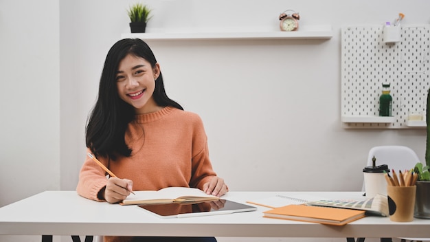 Portrait shoot graphic designer woman in creative office workplace.