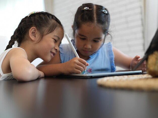 Portrait of siblings sitting on table