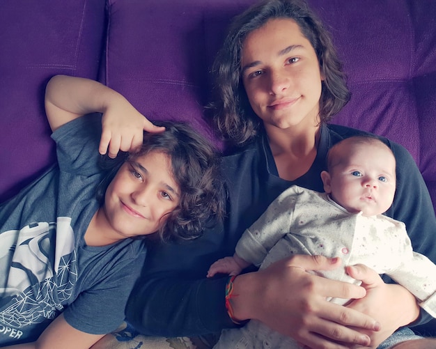 portrait of siblings on sofa
