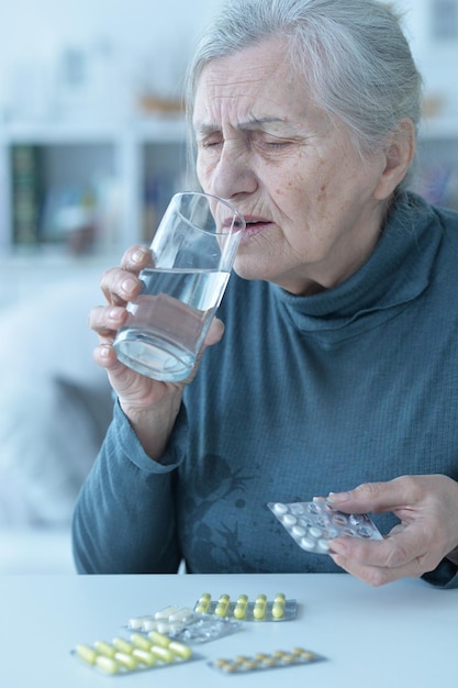 Portrait of sick senior woman at home