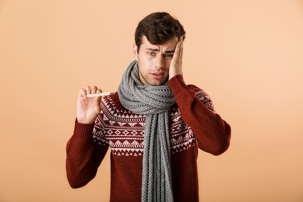 Portrait of a sick young man dressed in sweater