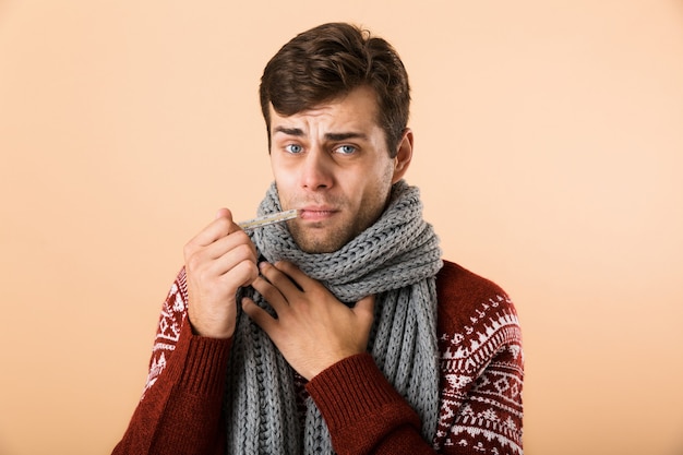 Portrait of a sick young man dressed in sweater